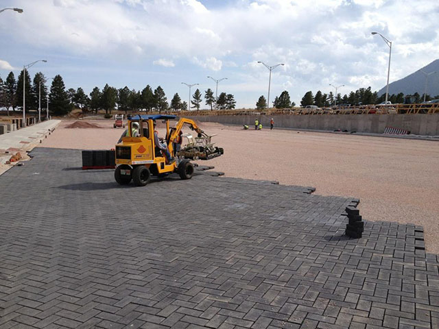 50,000 SF of Holland Stone 8cm installed mechanically.  Charcoal colored pavers for the main parking area and white pavers installed to represent the parking strips.